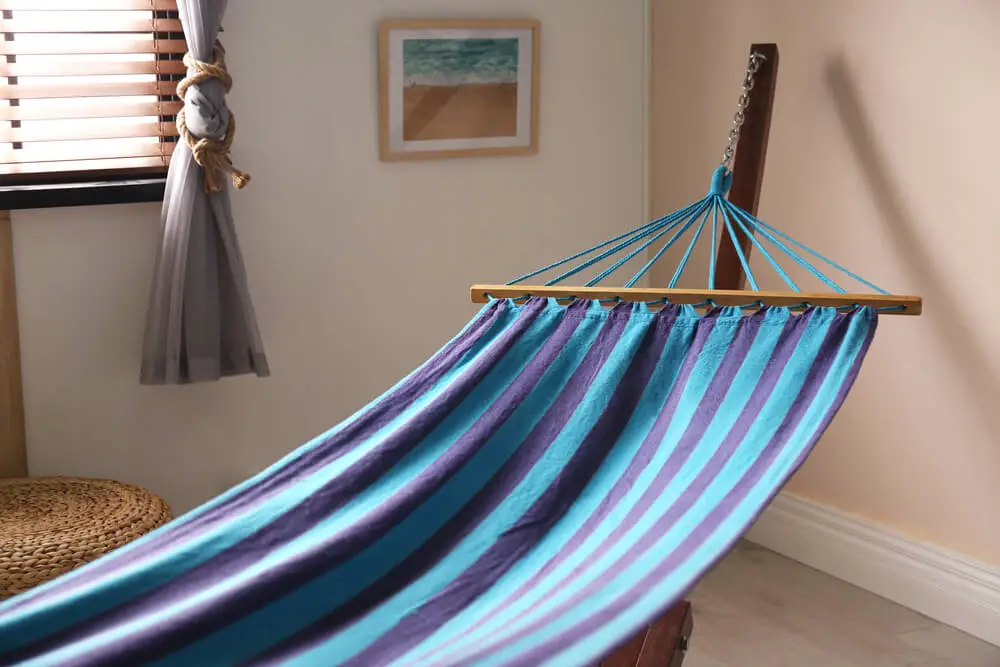Comfortable hammock in stylish room 